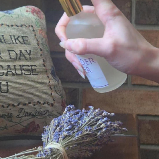 Lavender water spray misting into the air, evoking a calming, spa-like aromatherapy experience