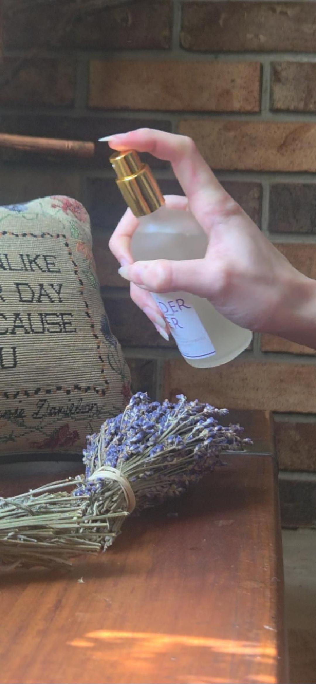 Lavender water spray misting into the air, evoking a calming, spa-like aromatherapy experience