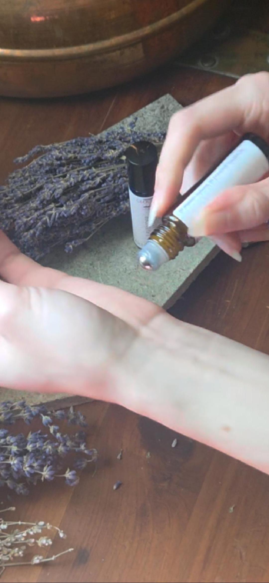 Lavender essential oil roll on from Cloudscape Hill applied to wrist — natural aromatherapy for stress, sleep, and calm